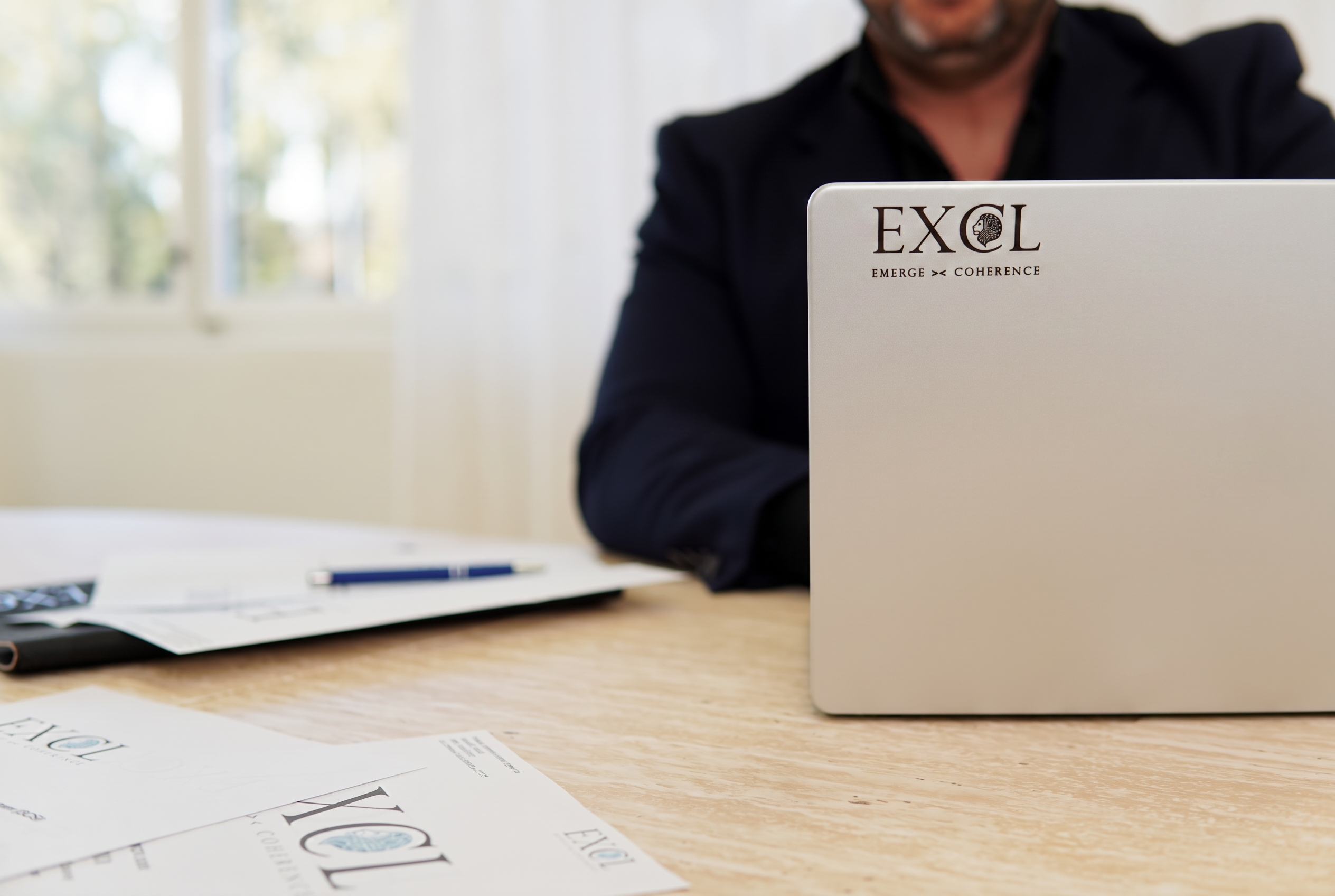 EXCL branded laptop in a systems engineering workspace